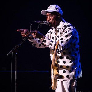 Buddy Guy on stage pointing both fingers at the audience