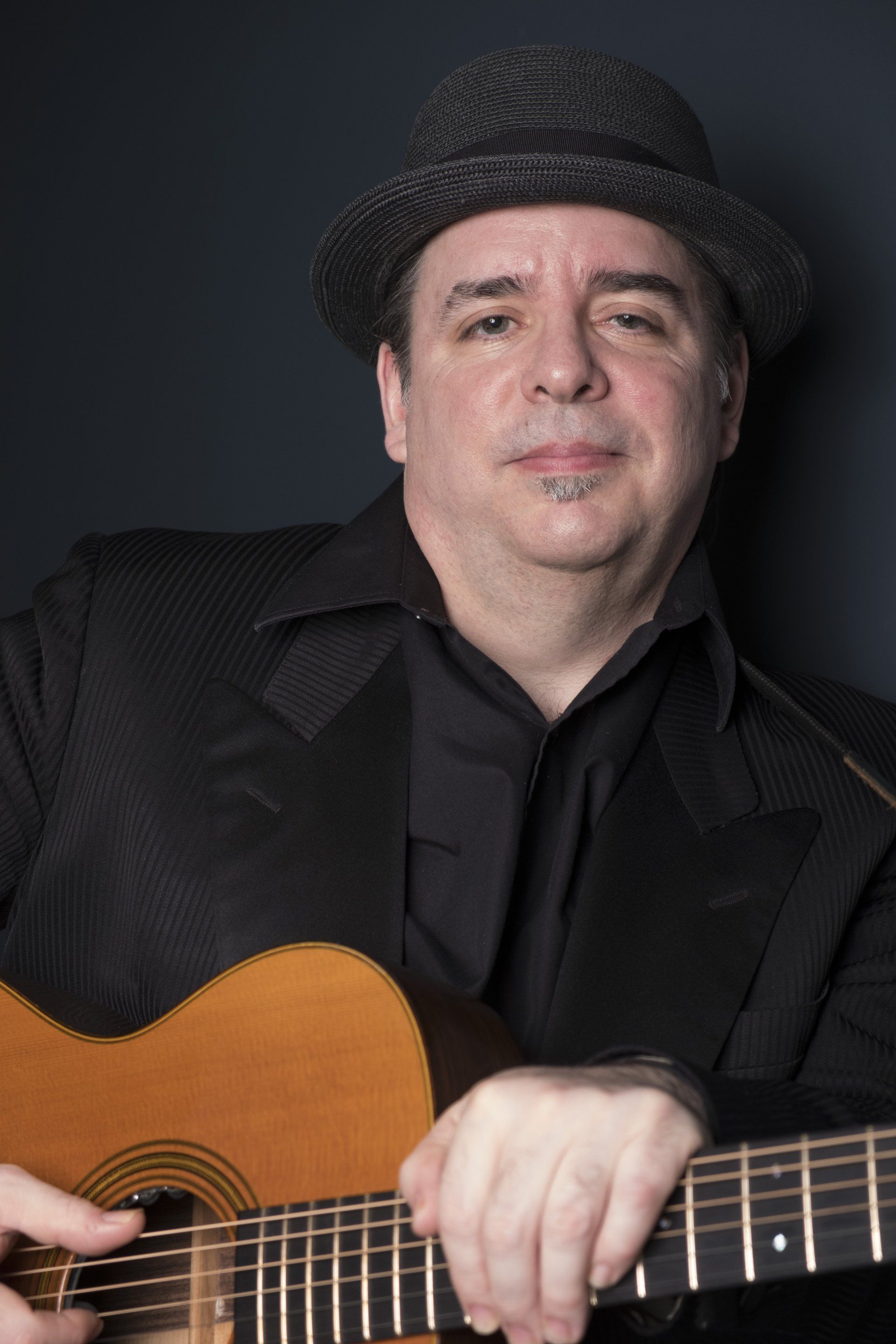Pat Loiselle posing with his acoustic guitar