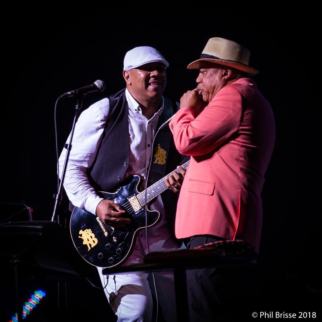 Ronnie Baker Brooks playing guitar on stage with Billy Branch playing harmonica