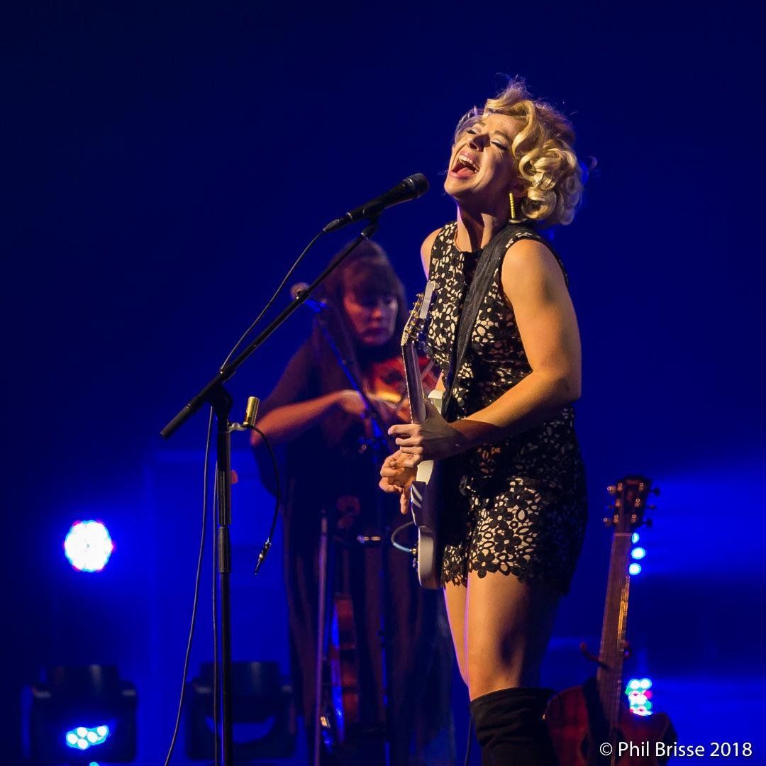 Samantha Fish singing and playing guitar on stage