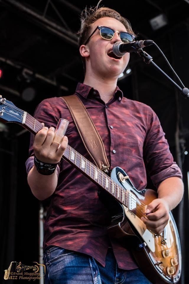Close up of Spencer Mackenzie singing on stage