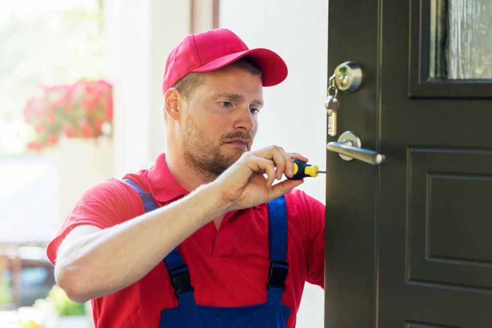 Man Fixing Door Lock — Houston, TX — Dixie Safe & Lock Service Inc. Man Fixing Door Lock — Houston, TX — Dixie Safe & Lock Service Inc.