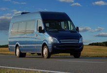 A minibus driving down a road