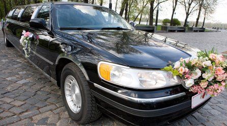 A wedding limo with flowers on it