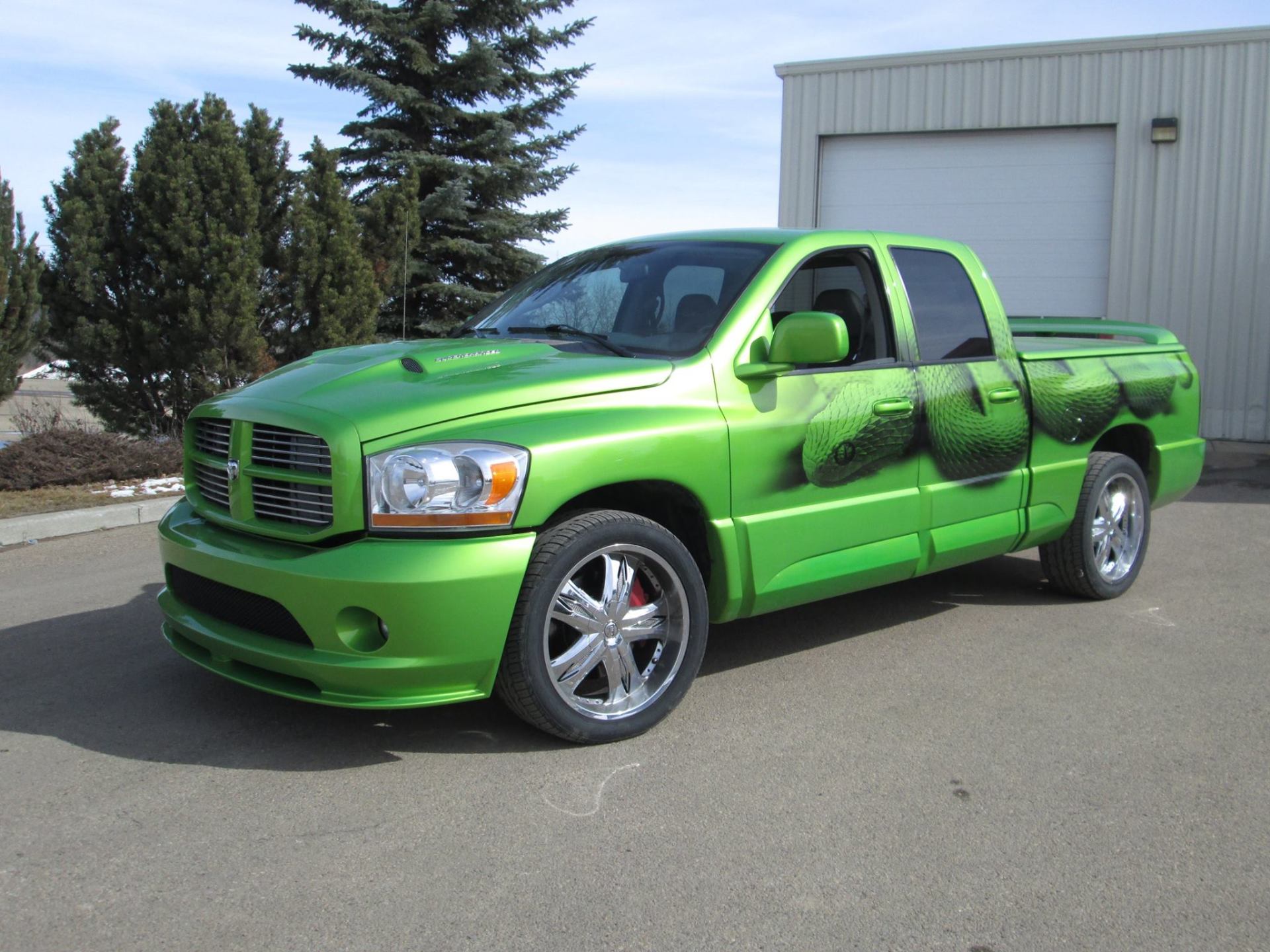 large lime green truck with black decorative decal paint job on it