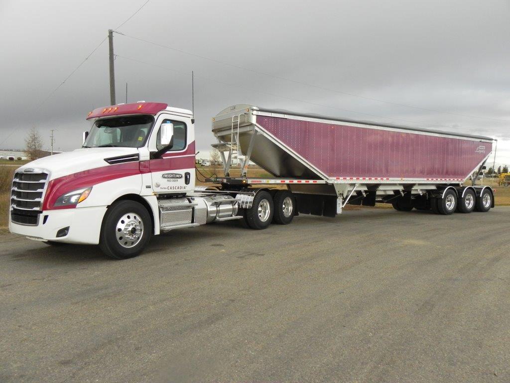 large white and pink cargo truck with full load