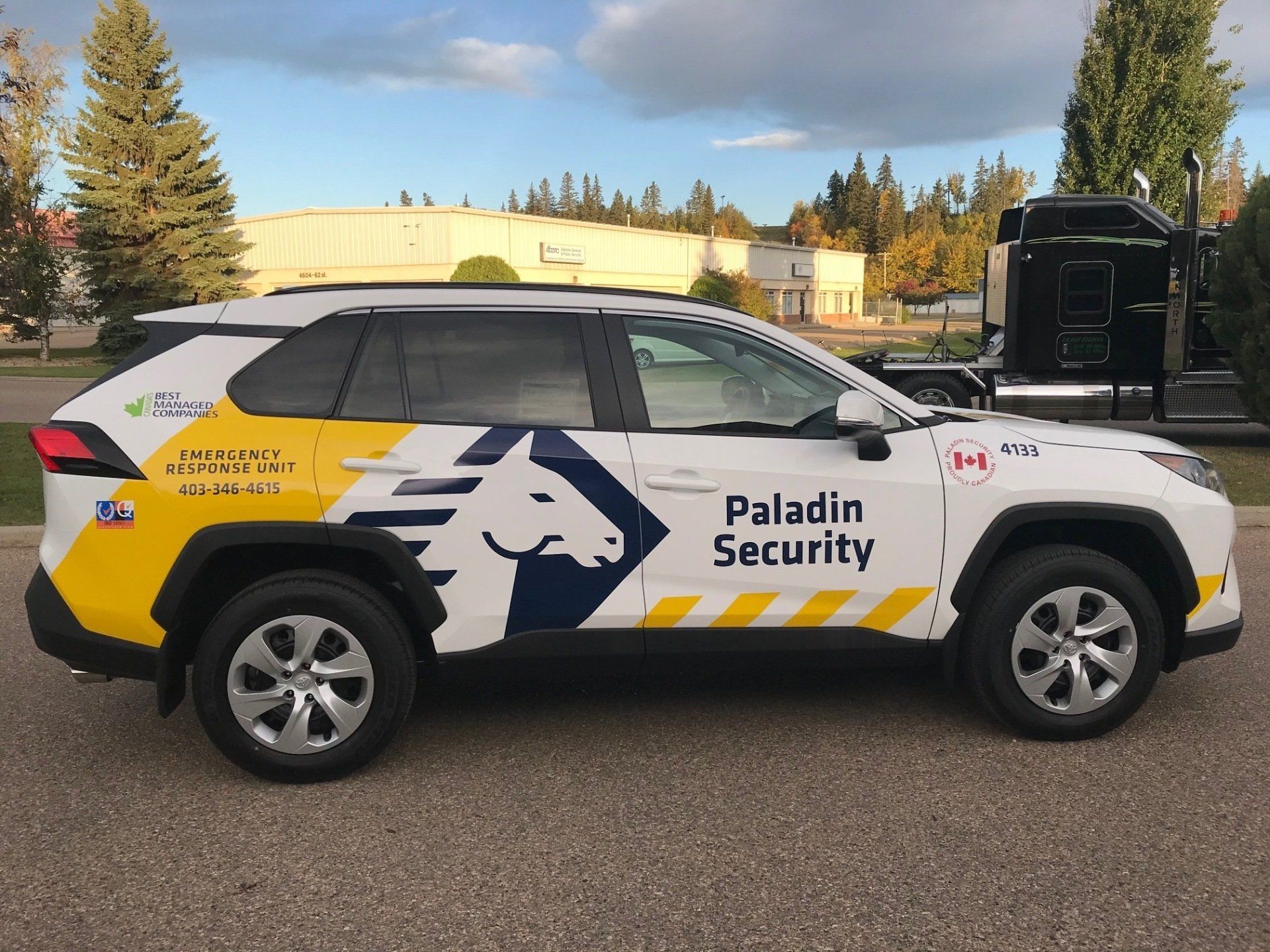 a paladin security vehicle is parked on the side of the road