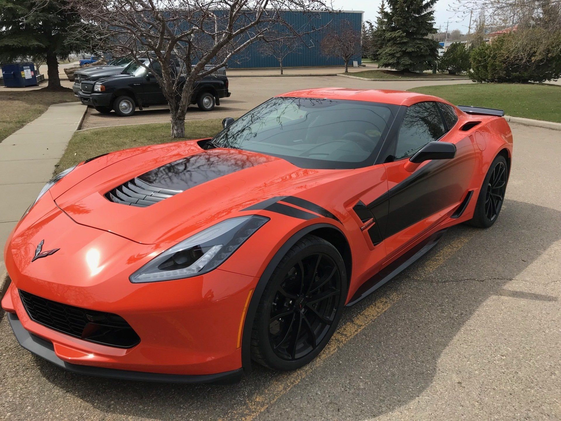 orange sports car with with black decals on it