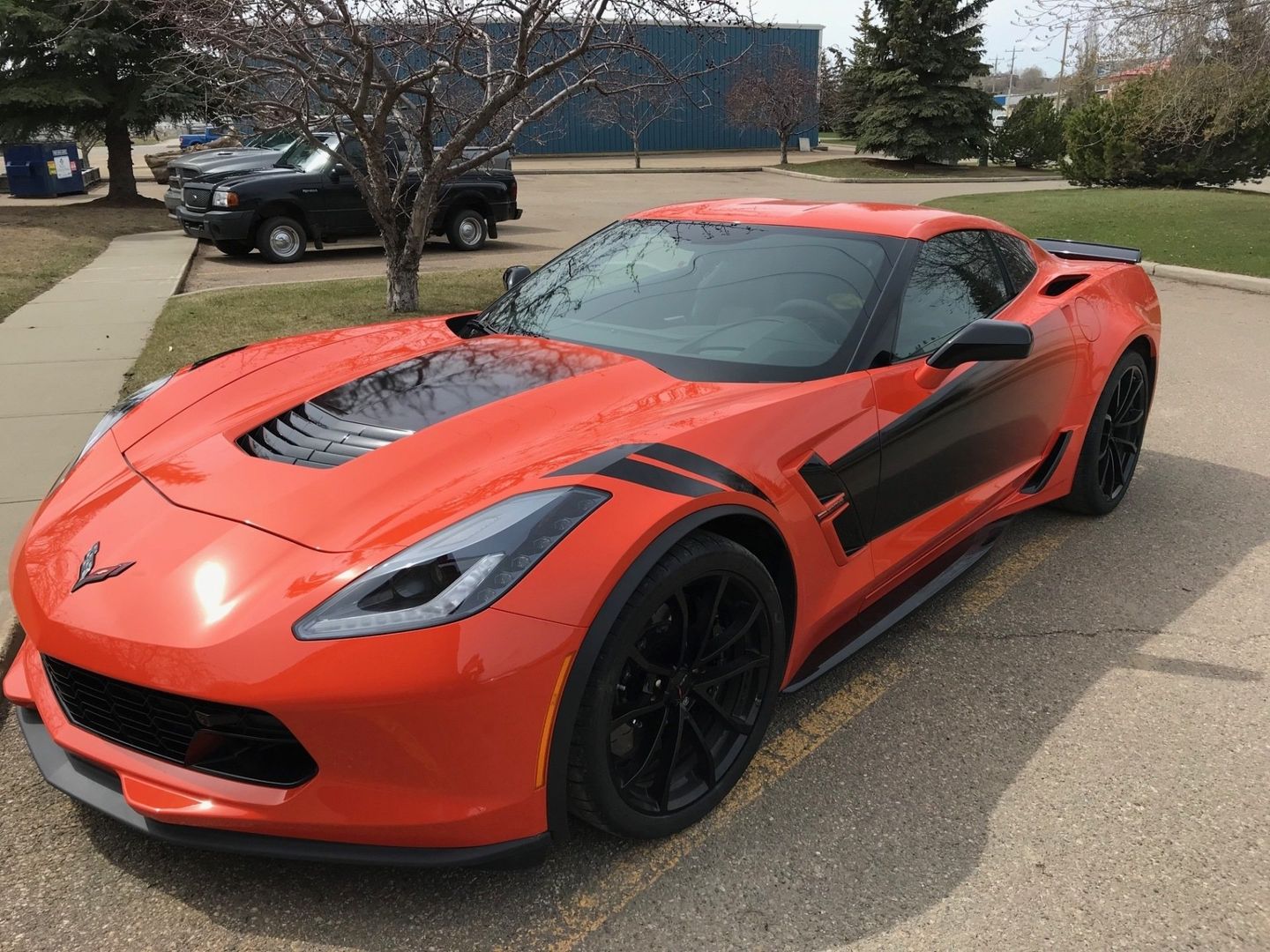 a red sports car is parked on the side of the road