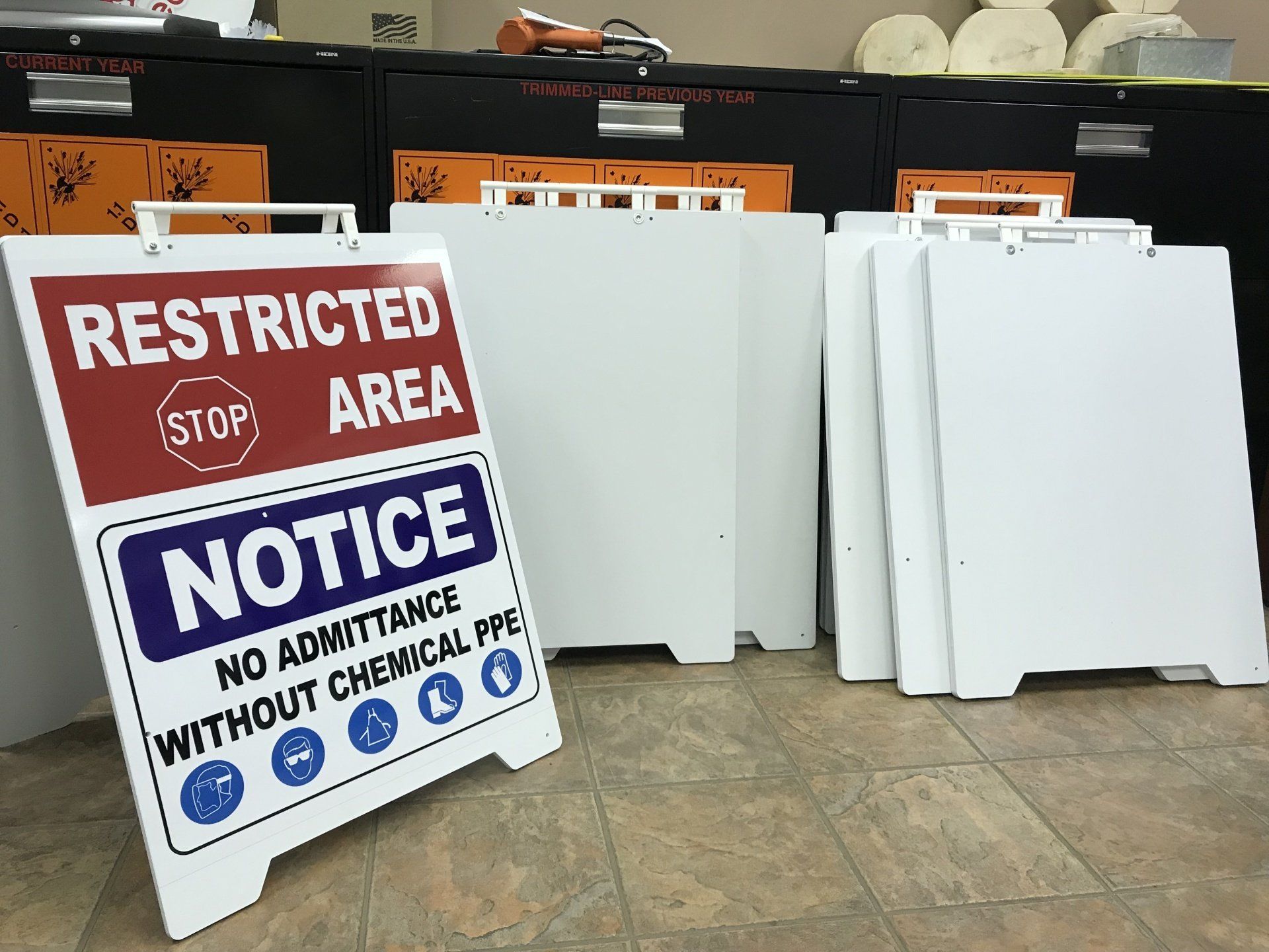 Sign with white writing on red and blue background next to white signs