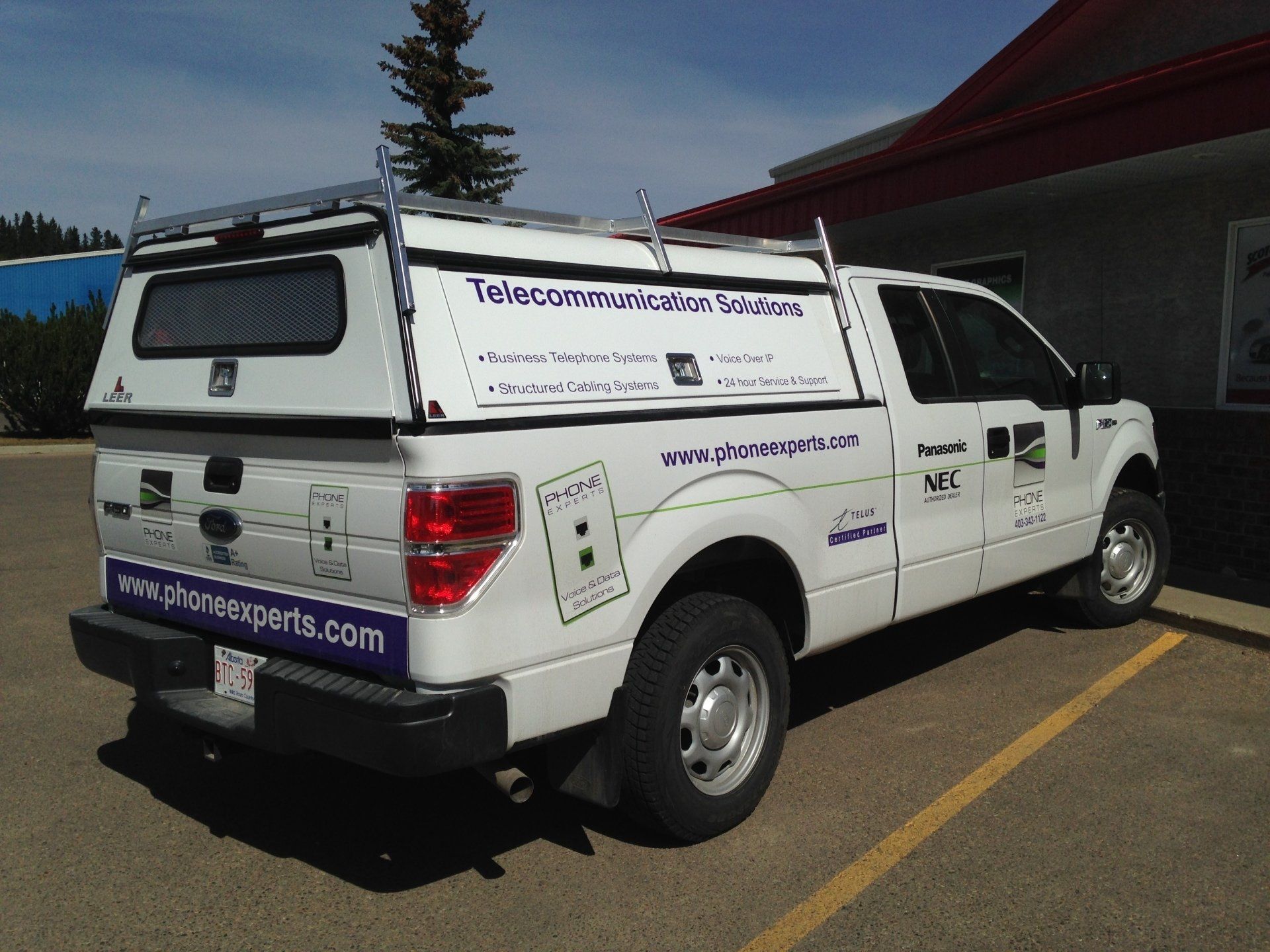 side view of white truck with paint job