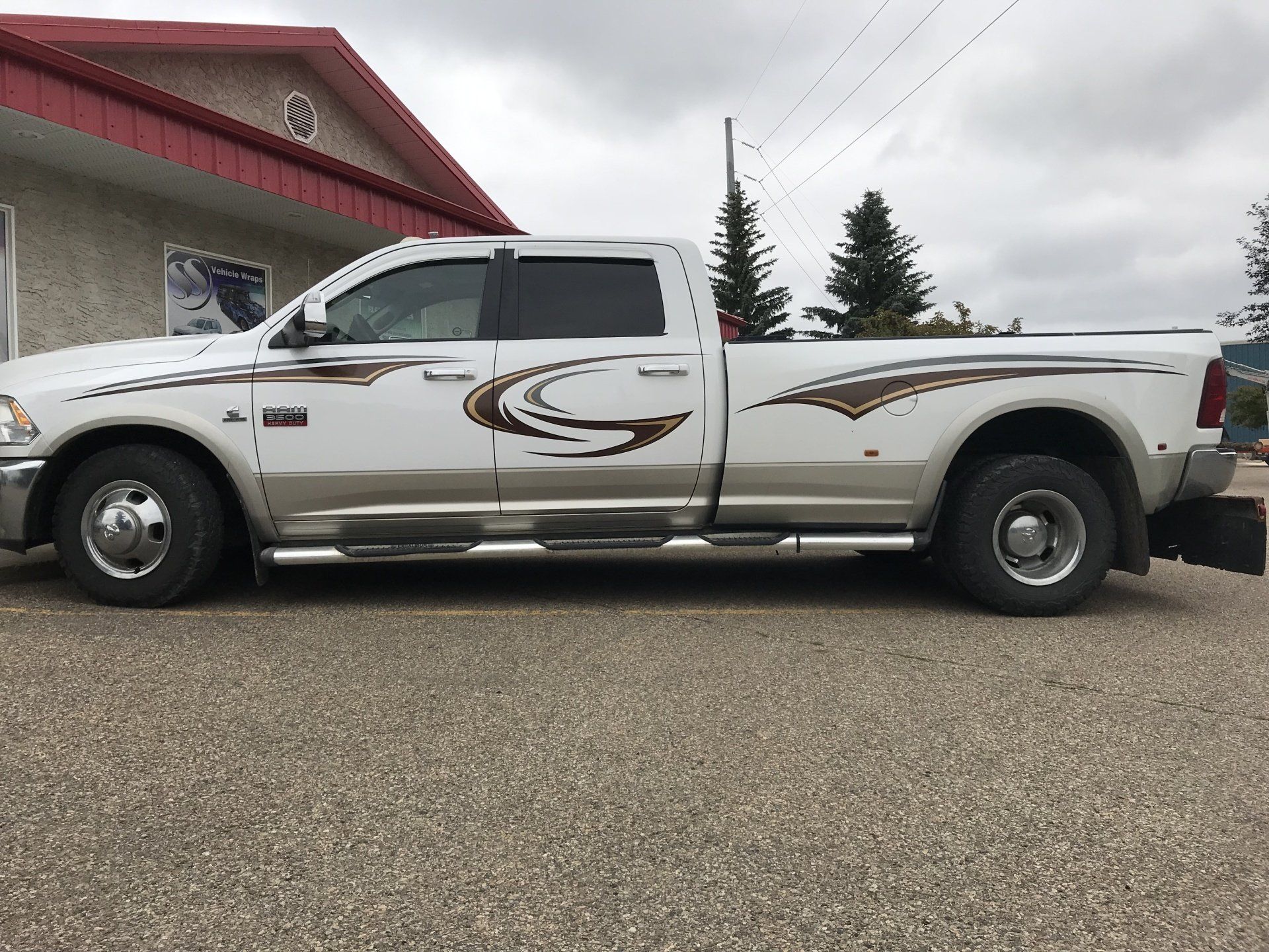 white truck with wavy decorative decals alongside it