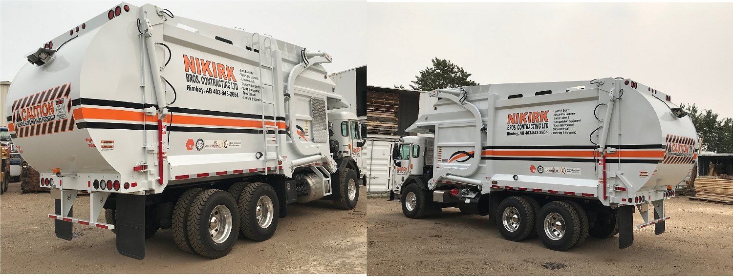 two garbage trucks with orange company logos