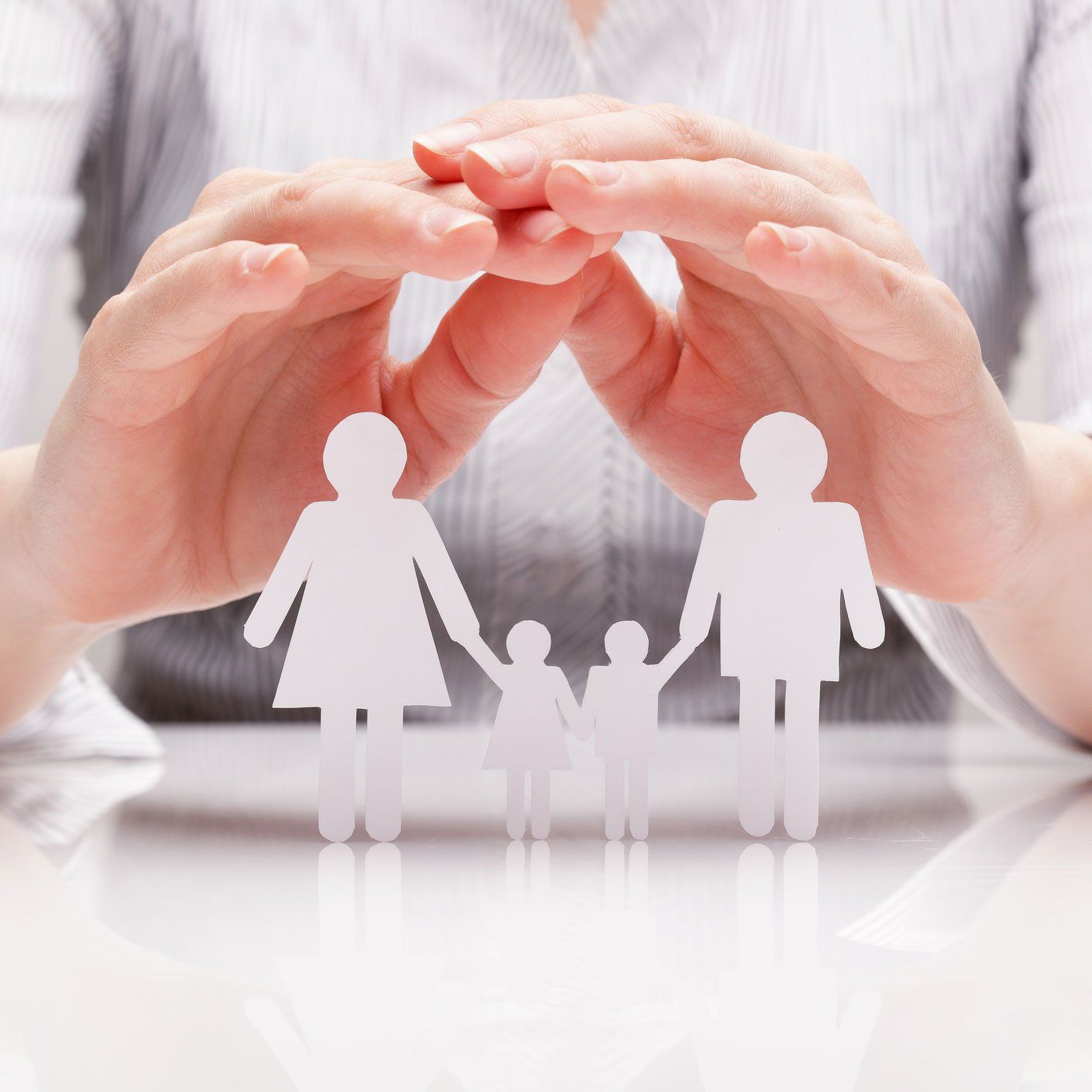 Hands Covering Origami of A Family — St. Joseph, MO — Ritchie, Soper & Schutt, LLC Family Law