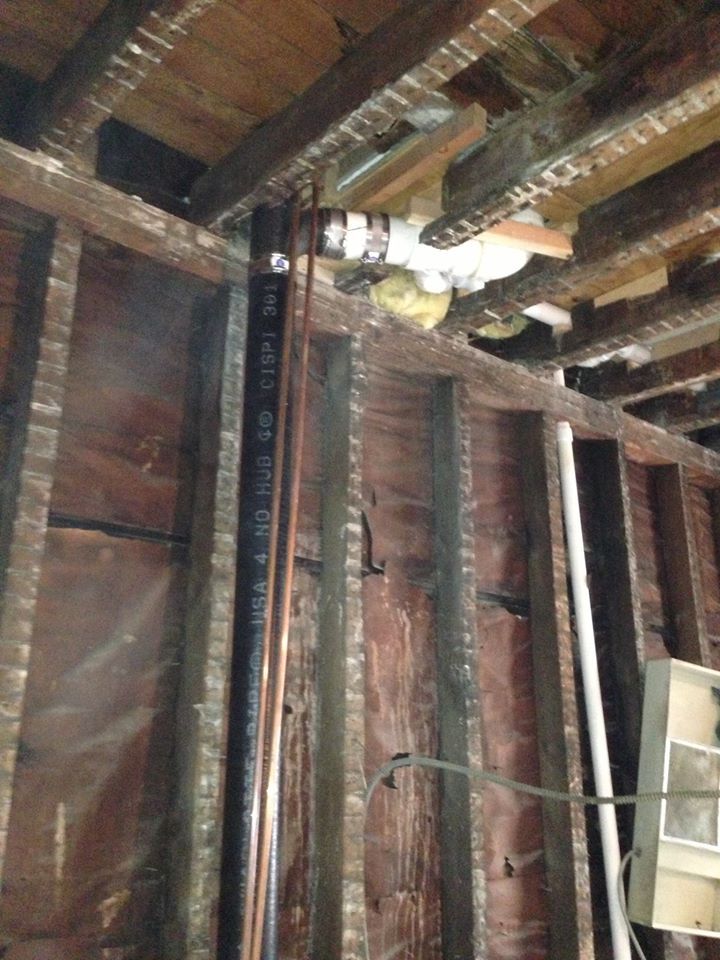 A copper pipe is hanging from the ceiling of a building