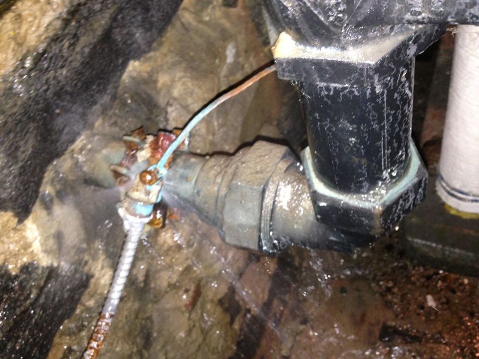 A close up of a pipe with water coming out of it.