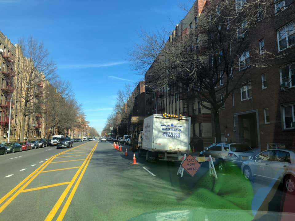 A white truck is parked on the side of the road.