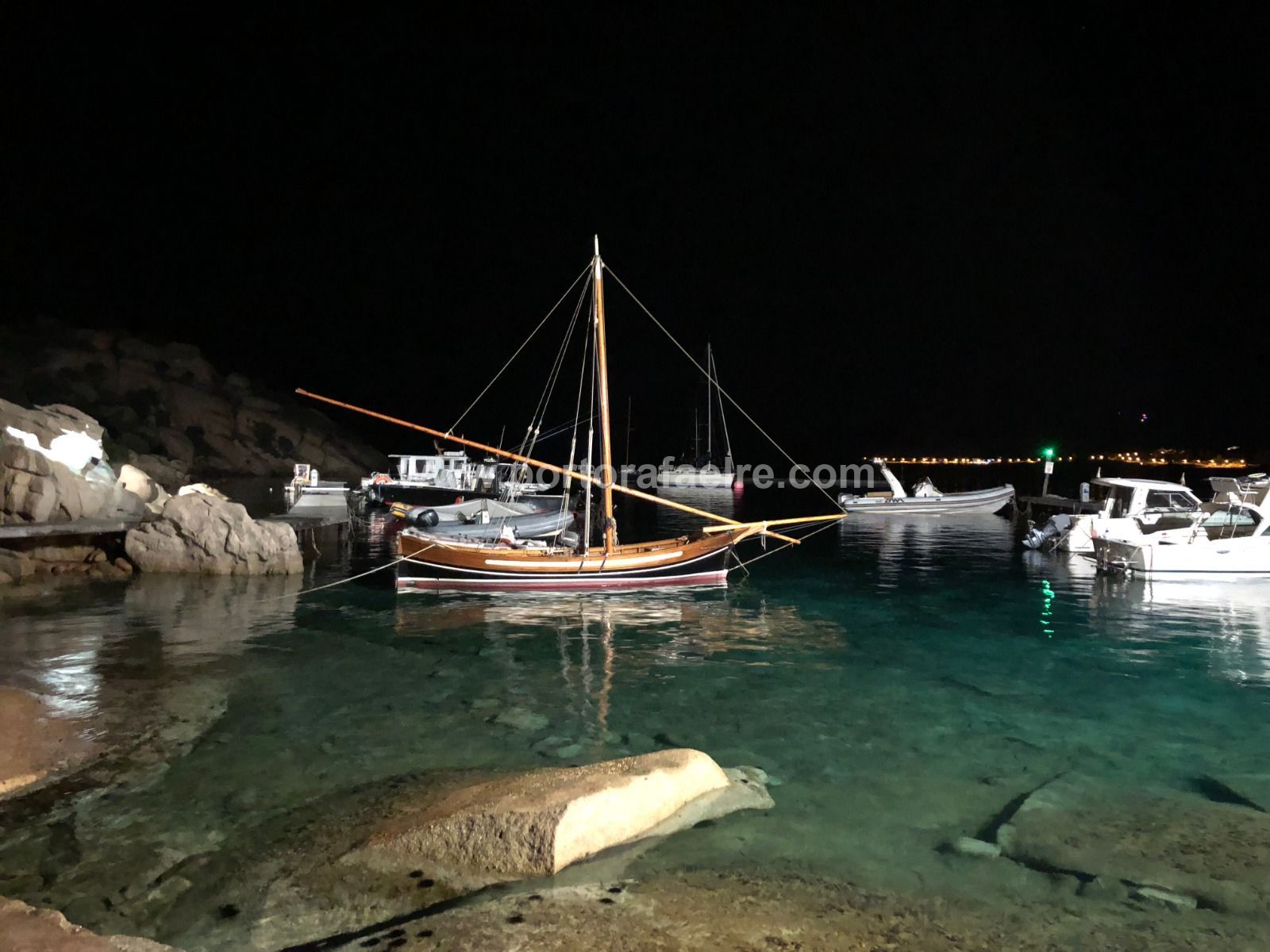 a boat is docked in a harbor at night