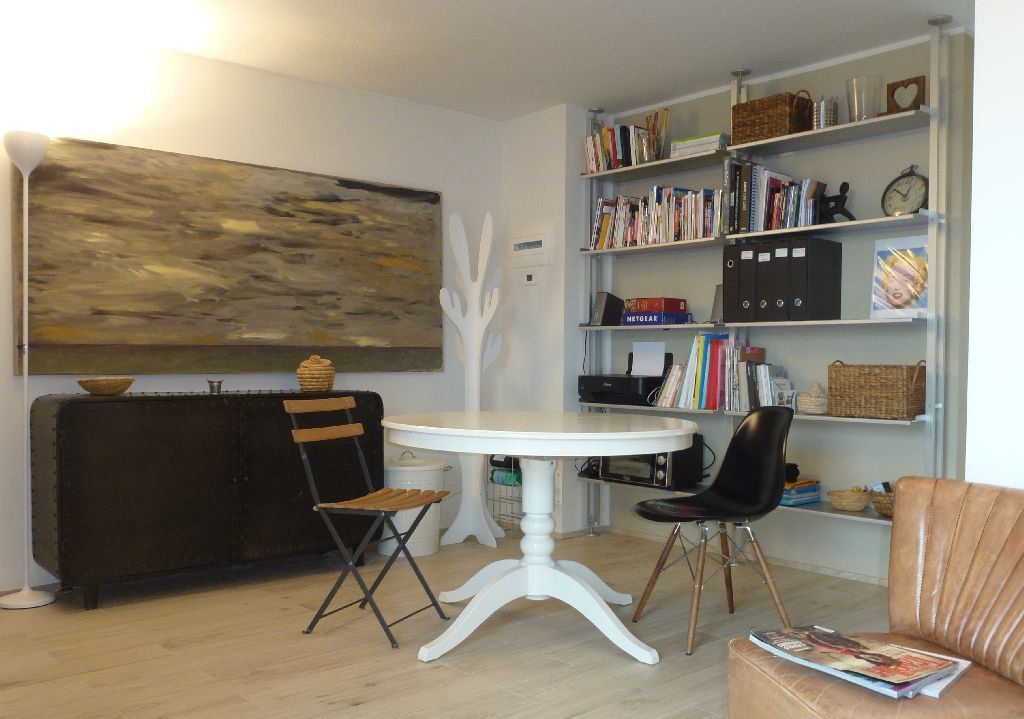 a living room with a white table and chairs
