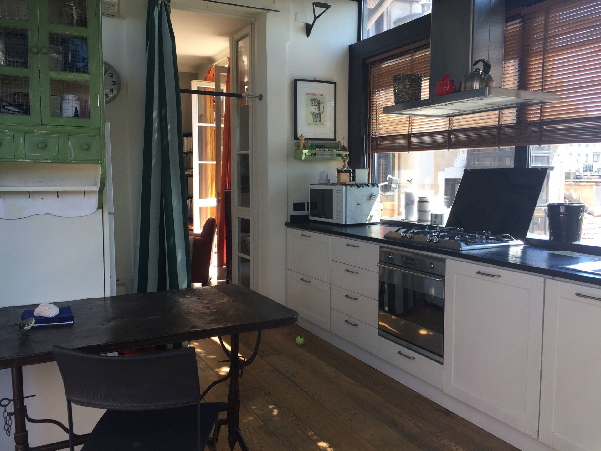 a kitchen with white cabinets and black counter tops