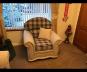 Patterned armchair in front of a window