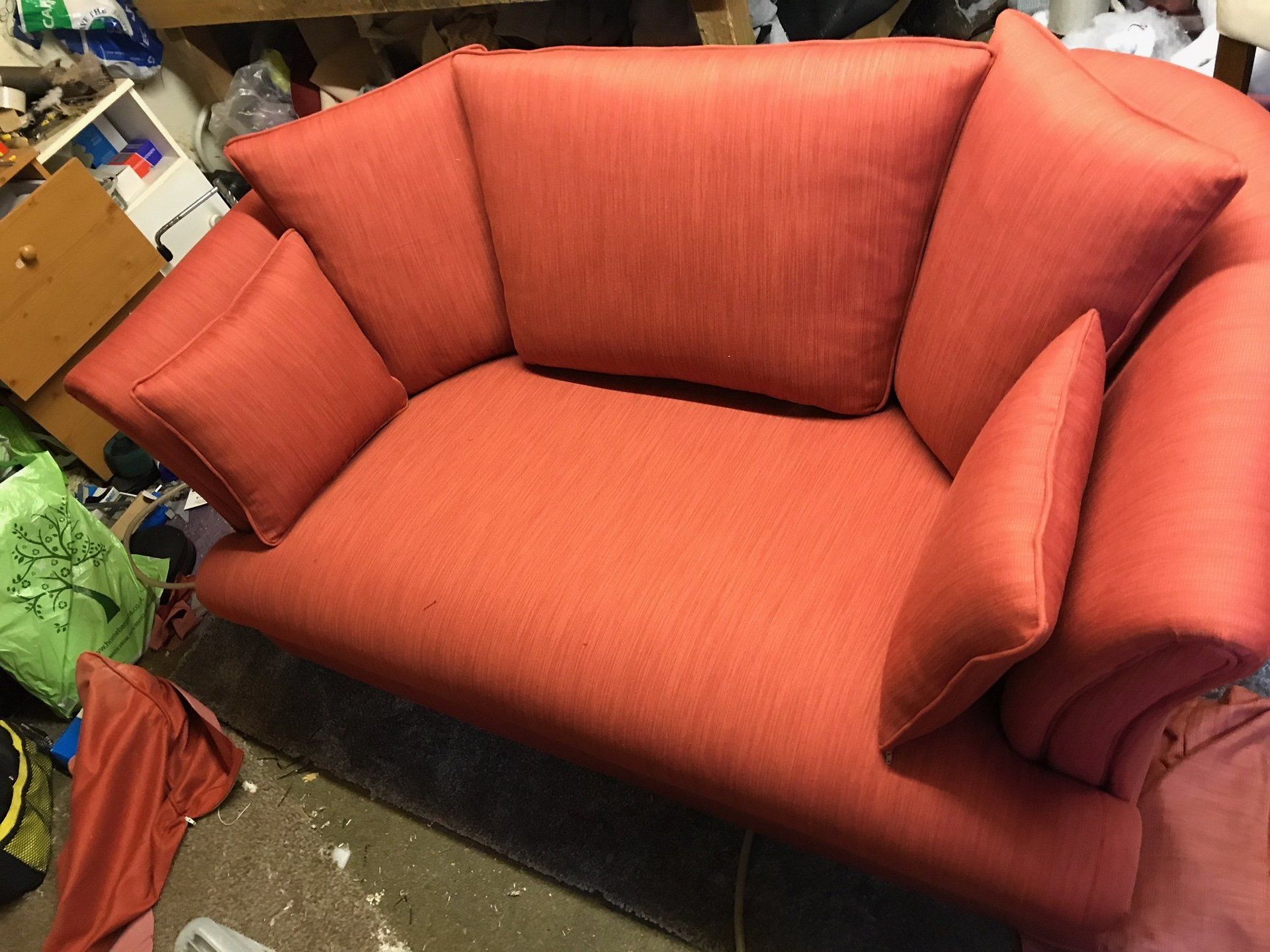 A small and plump orange sofa