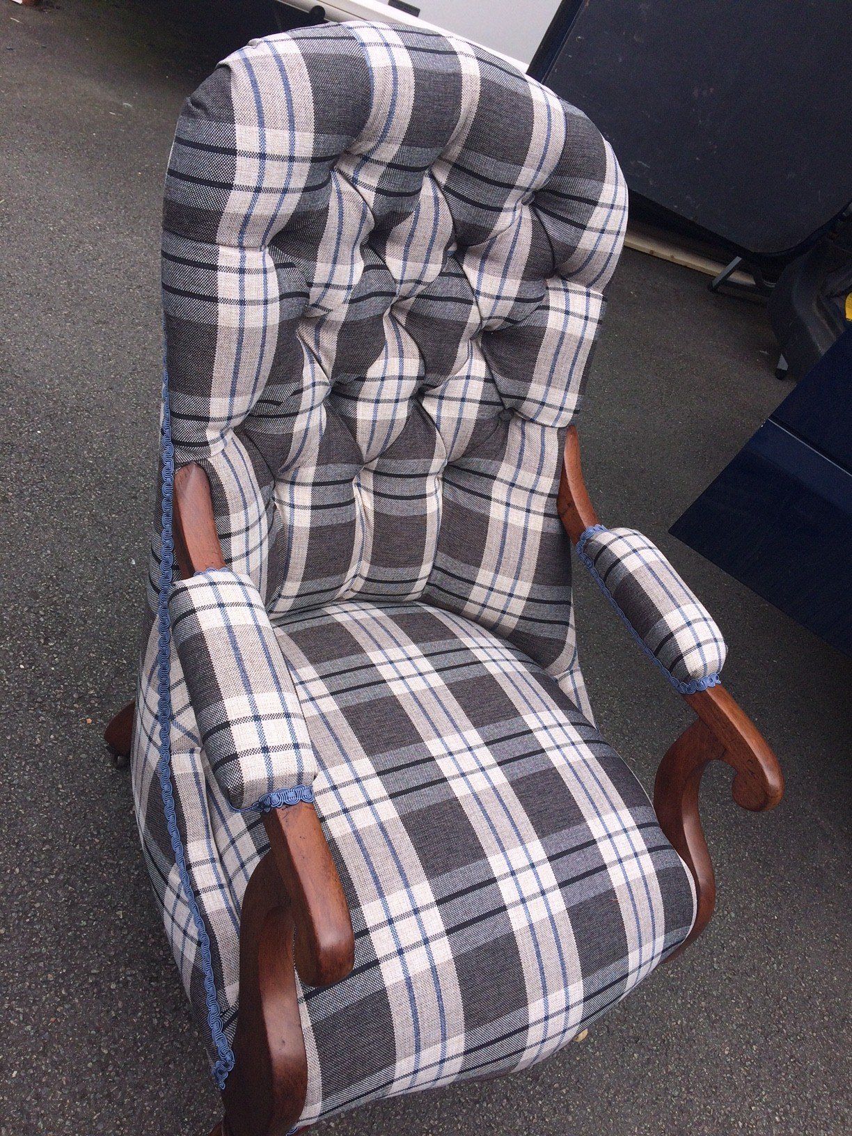Blue and white check patterned chair with wooden arms