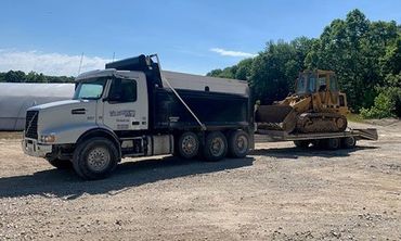 Truck Carrying Backhoe — Foristell, MO — Wildschuetz Bros. Trucking Inc Truck Carrying Backhoe — Foristell, MO — Wildschuetz Bros. Trucking Inc