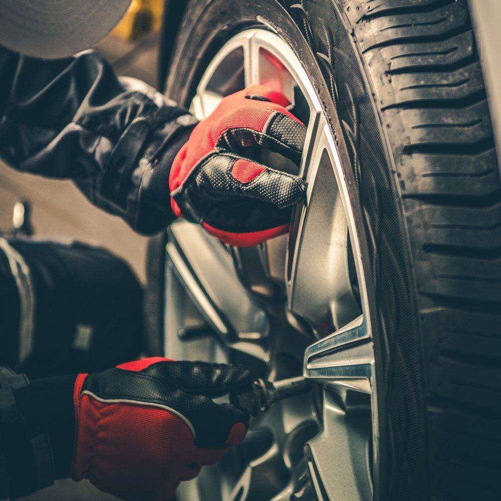 Mechanic Installing Car Tire — San Angelo, TX — Caddo Street Wheel Alignment & Brake Shop, Inc