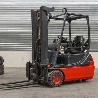 Forklift machinery parked in warehouse