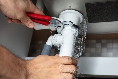 Fixing Sink Pipe With Adjustable Wrench — Spring Valley, CA — Infinity Plumbing & Construction Inc. Fixing Sink Pipe With Adjustable Wrench — Spring Valley, CA — Infinity Plumbing & Construction Inc.