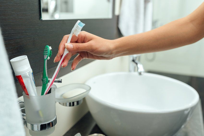 Woman Takes A Toothbrush — Port Orange, FL — Advanced Dental Care Woman Takes A Toothbrush — Port Orange, FL — Advanced Dental Care