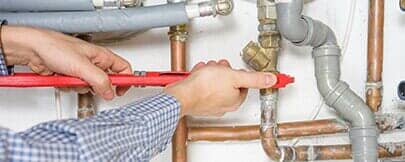 Plumber fixing the heating system — sewer line service in Ozark, MO Plumber fixing the heating system — sewer line service in Ozark, MO