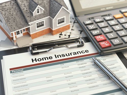 A home insurance file surrounded by a miniature house and a calculator - Restoration 1 of Morris County