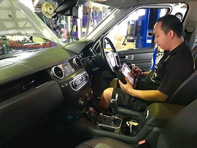 Man Surveying Car — Motor Centre in Cairns, QLD Man Surveying Car — Motor Centre in Cairns, QLD