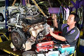 Man Working on Engine — Motor Centre in Cairns, QLD Man Working on Engine — Motor Centre in Cairns, QLD