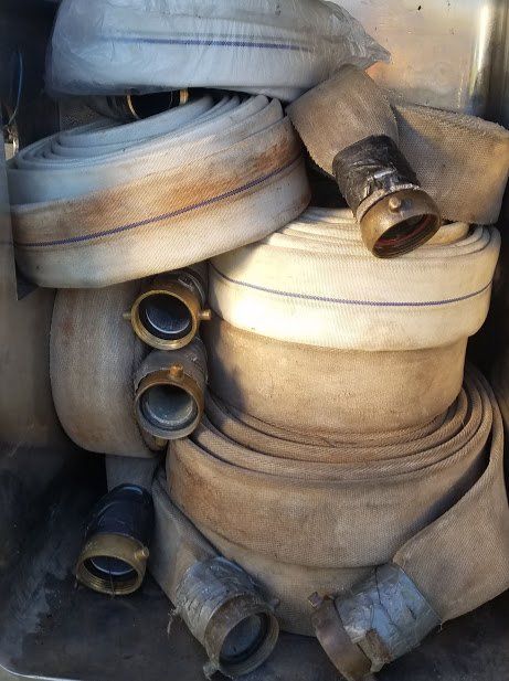 A bunch of fire hoses are stacked on top of each other