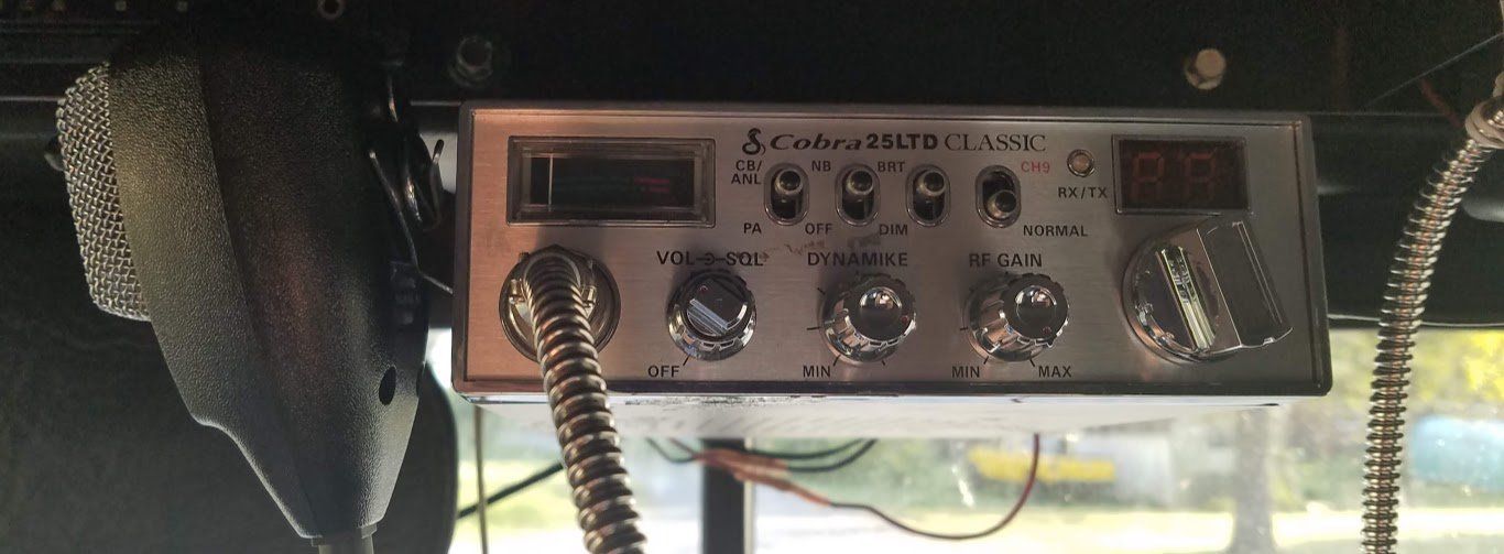A close up of a radio in a car with a digital display