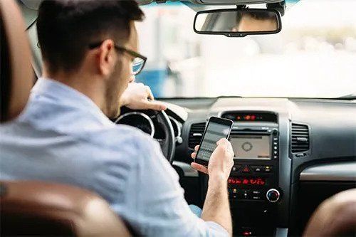 Man Driving While Texting — Tucker, Ga — Taggart's Driving School Man Driving While Texting — Tucker, Ga — Taggart's Driving School