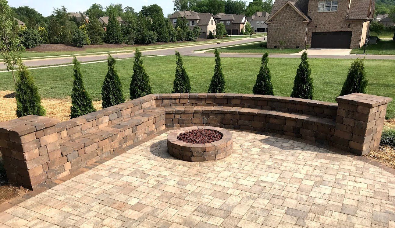 firepit with brick seating wall behind