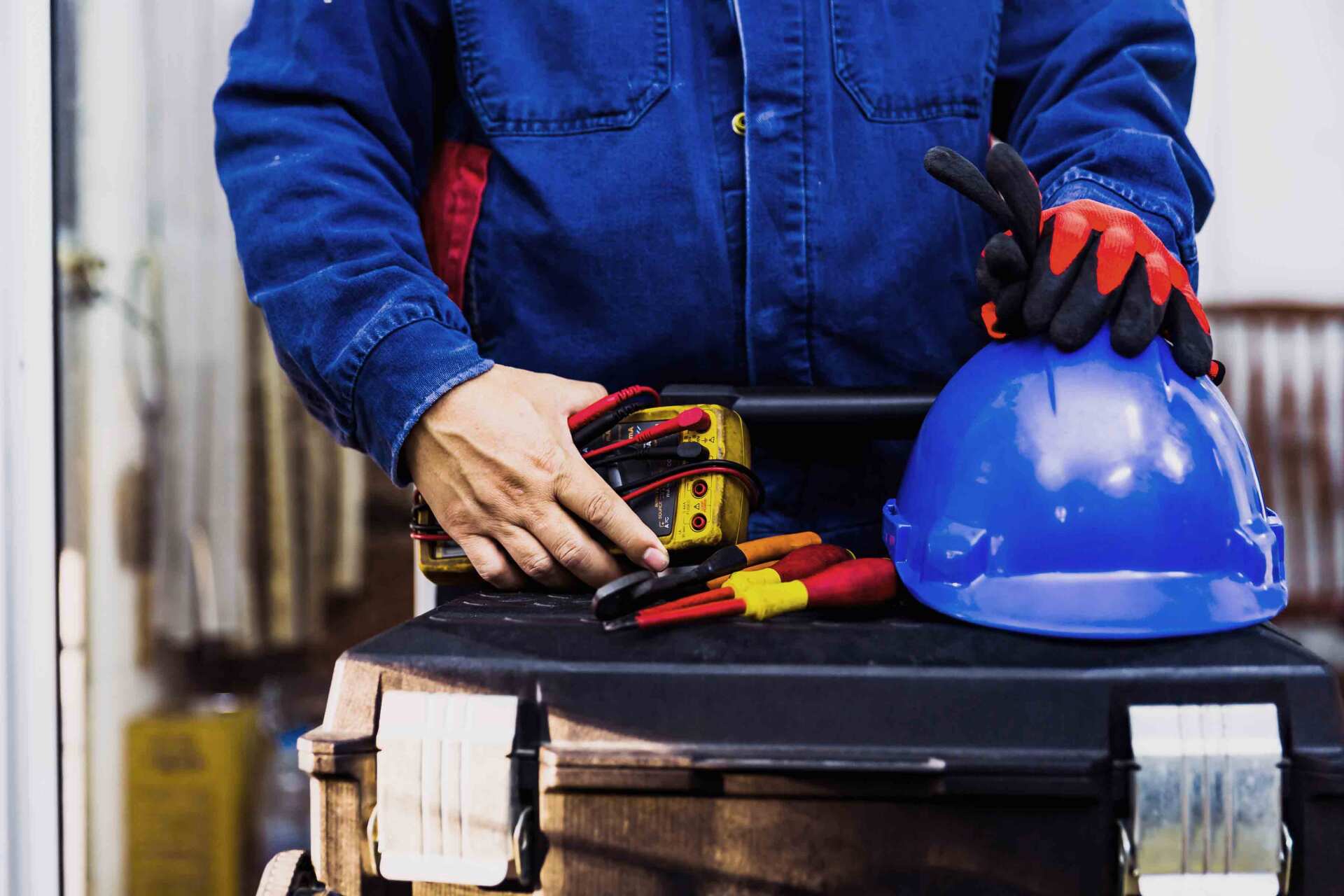 An Electrician Holding Electrical Tools — Electricians in Gold Coast, QLD