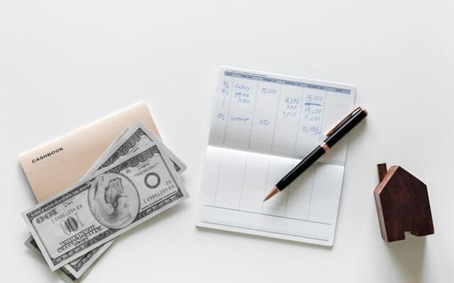 A checkbook and cash