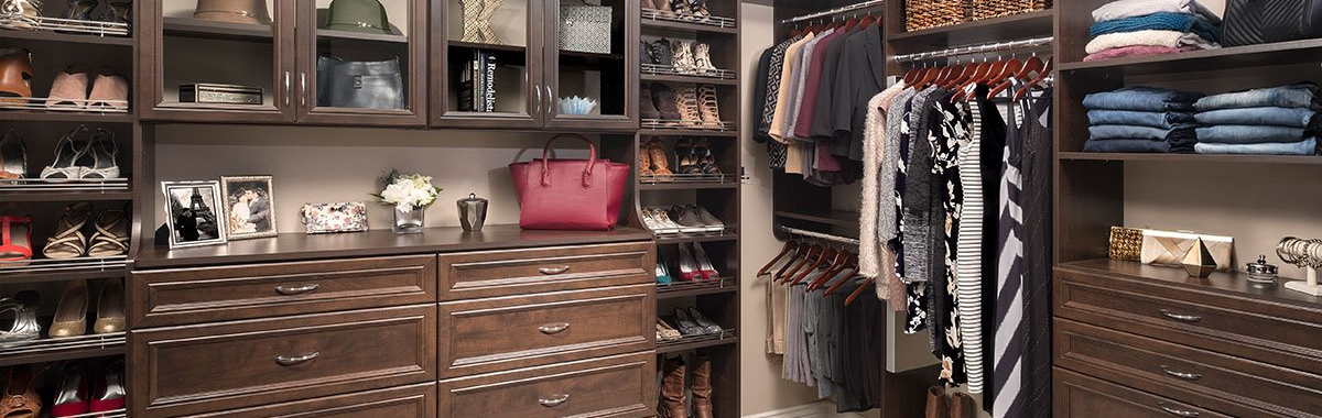 A large walk in closet filled with lots of clothes and shoes.