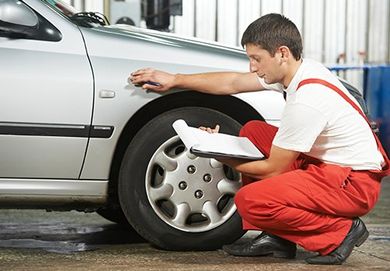 Auto Mechanic Repairman Inspecting Car — Auto Repair in Wellsville, PA Auto Mechanic Repairman Inspecting Car — Auto Repair in Wellsville, PA