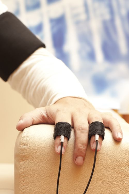 Accused finger connected with polygraph machine