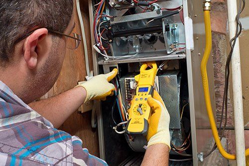 technician testing metrics of furnace
