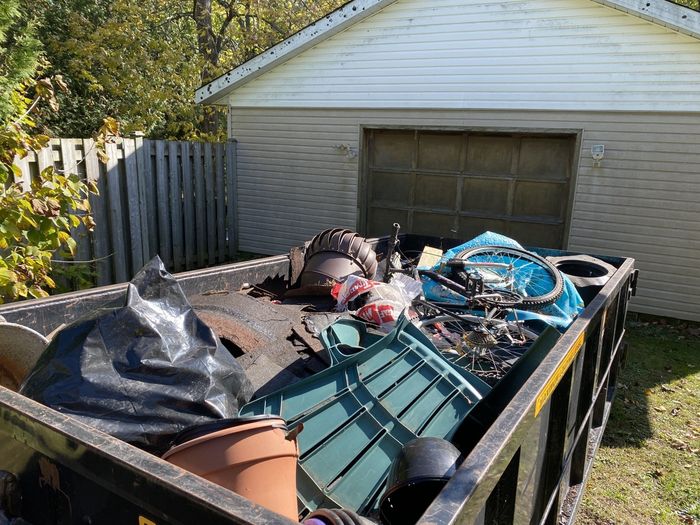 loaded dumpster with junk in owen sound, on