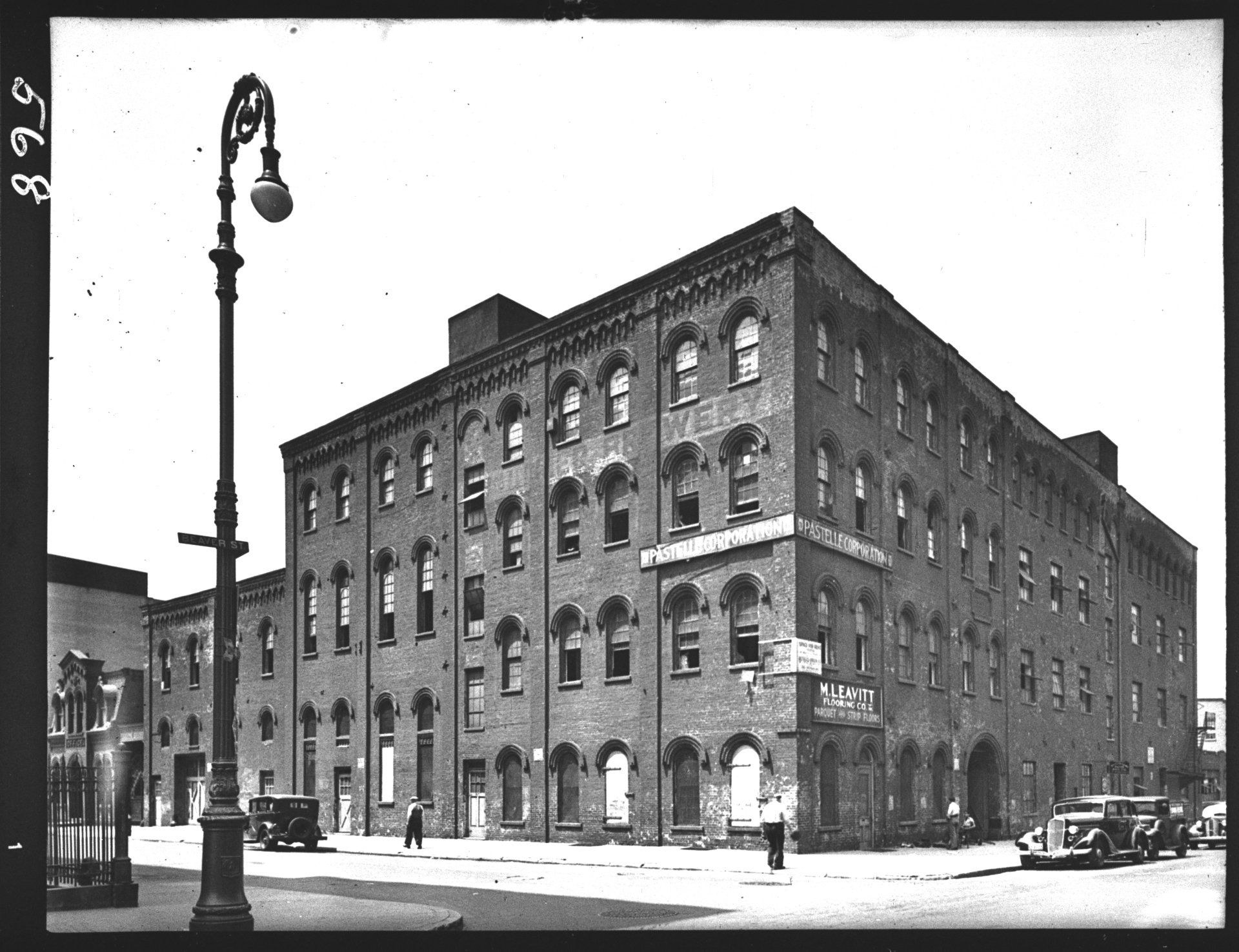 A black and white photo of a large brick building