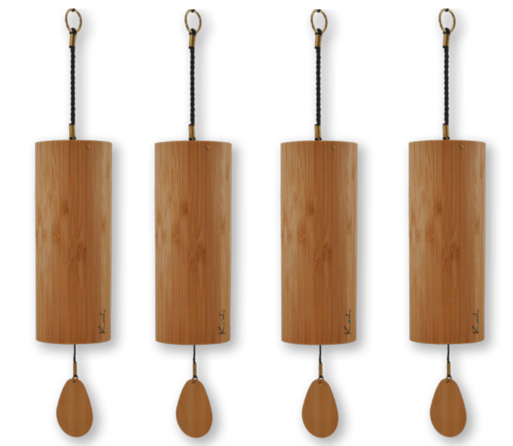 Four wooden bells are lined up in a row on a white background