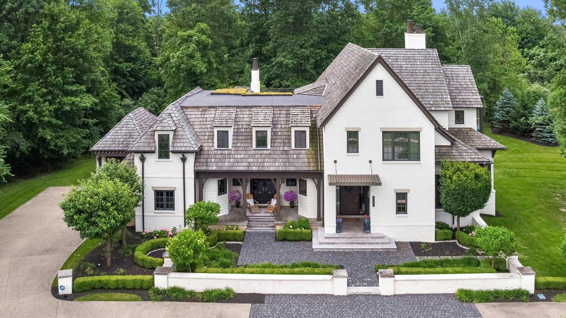 A large white house with a driveway leading to it